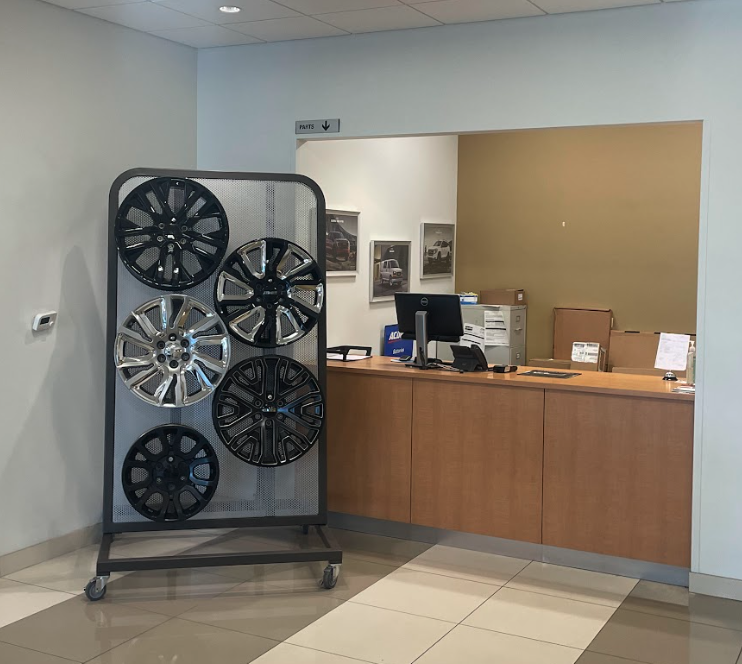 Buick and GMC accessory wheel display near the parts counter at Crain Buick GMC in Conway, Arkansas